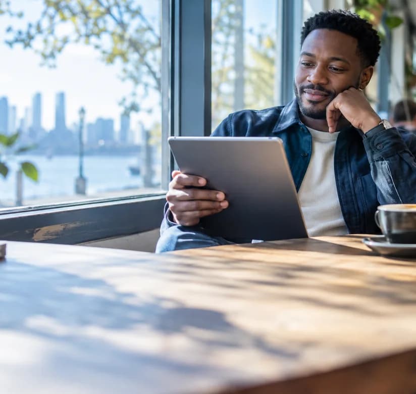Reader using a tablet in a café